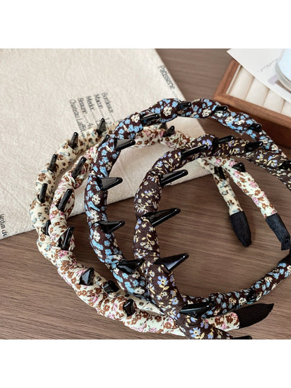 Side view of floral print headband showing elastic back for comfortable fit