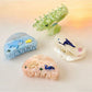 Side view of Beau Coastal Ocean Series acetate hair clip highlighting curved design