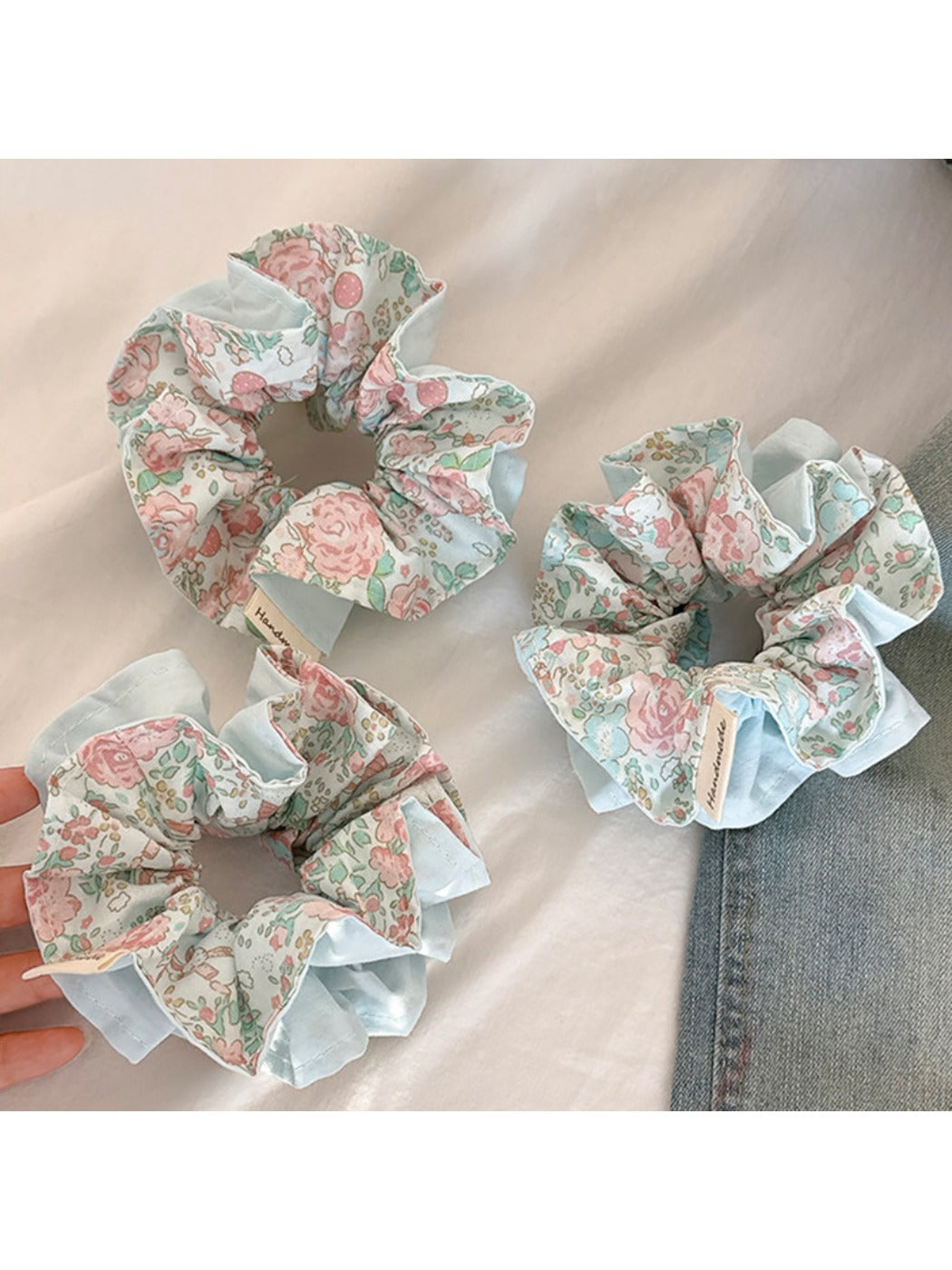 Close-up of a sweet blue ruffled scrunchie made of soft fabric