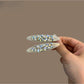 Beau hair clip displayed on a white background highlighting its shine and design