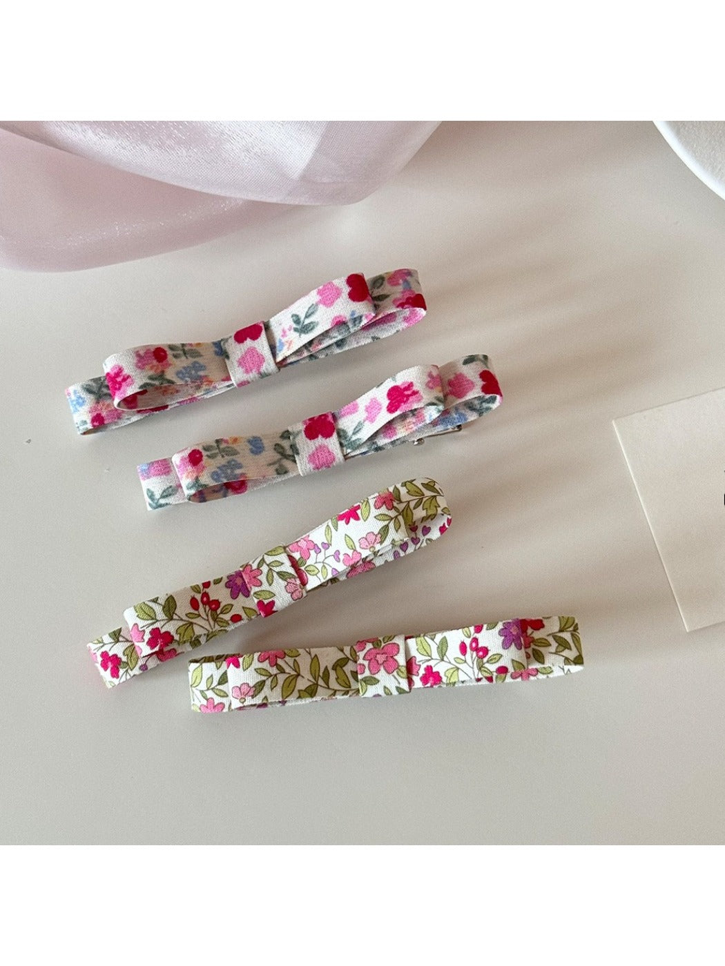 Beau Sweet Floral Print Hair Clip showing pink and white flowers on a curved clip