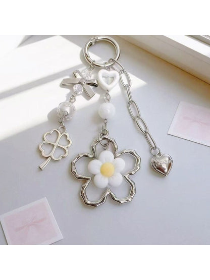 Minimalist modern flower charm keychain with silver ring on white background