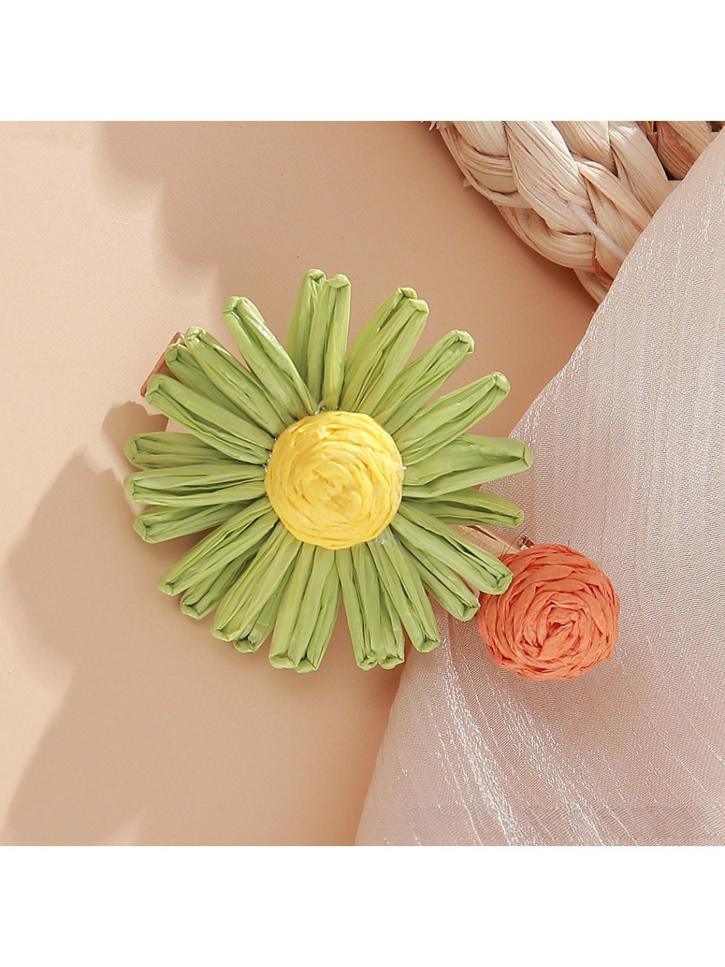 Beau raffia woven strawberry flower hair clip with visible green leaves detail