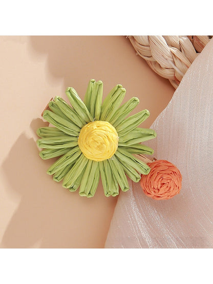 Beau raffia woven strawberry flower hair clip with visible green leaves detail