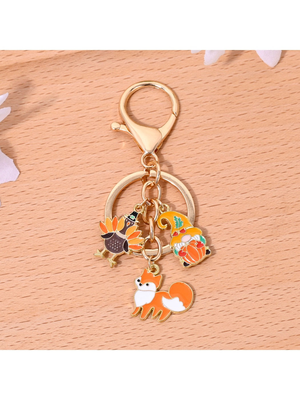 Close-up of the orange alloy keychain showing its smooth finish and metal texture