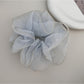 Gifty scrunchie worn on a wrist as a stylish accessory