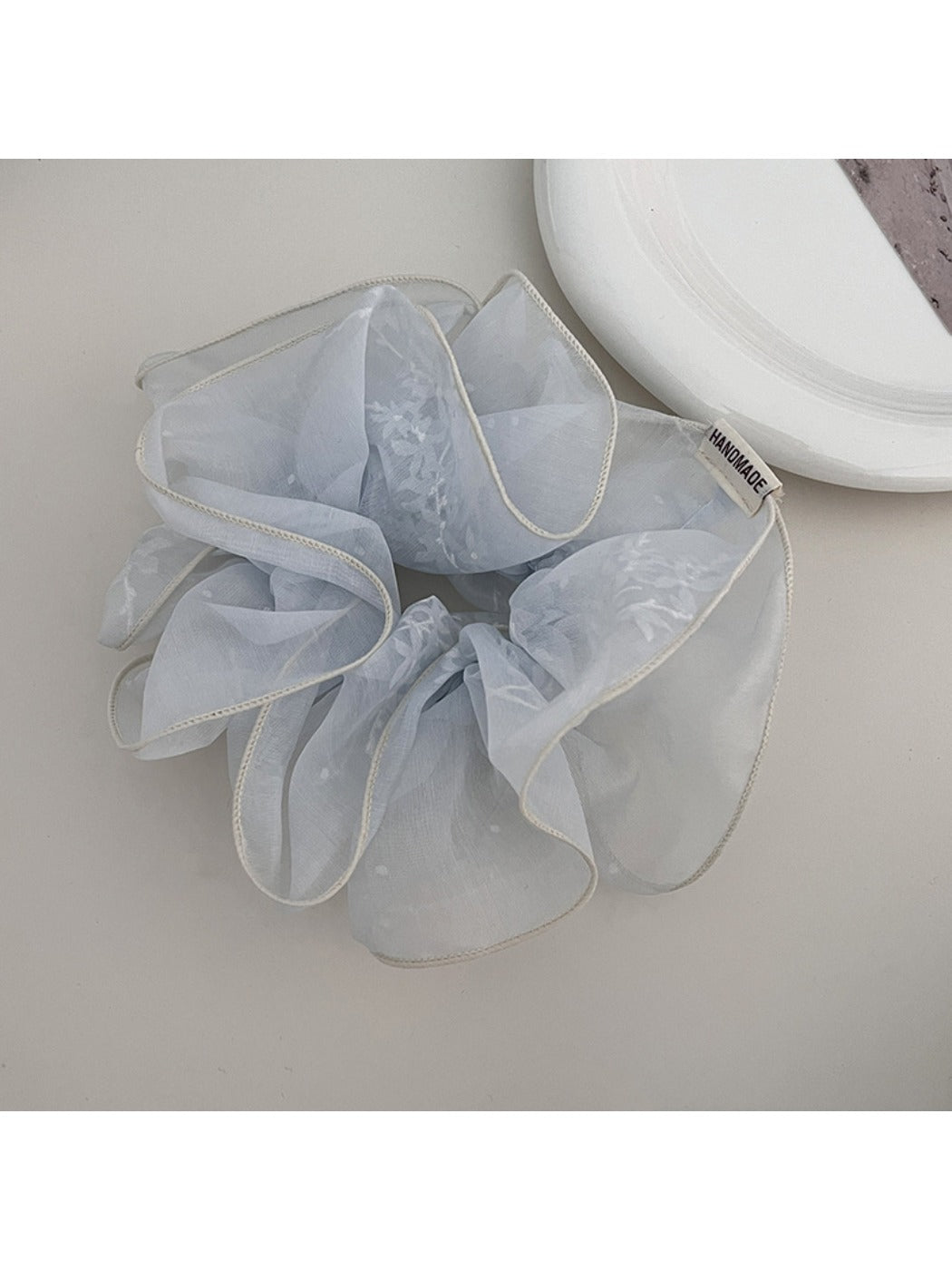 Gifty scrunchie worn on a wrist as a stylish accessory