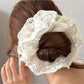 Side view of Gifty floral scrunchie showing delicate lace trim detail