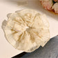 Close-up of Gifty minimalist vintage print scrunchie with muted floral pattern