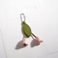 Pink tulip keychain displayed next to a small gift box