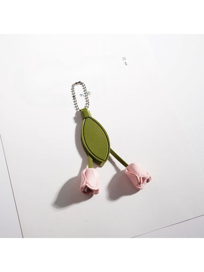 Pink tulip keychain displayed next to a small gift box
