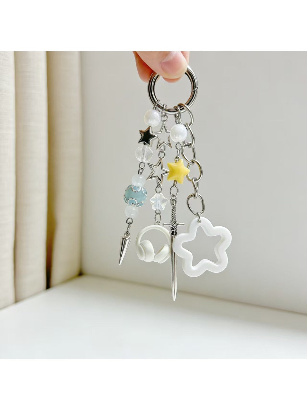Gold keychain featuring a small star charm hanging from a circular ring