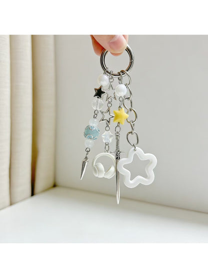 Gold keychain featuring a small star charm hanging from a circular ring