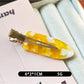 Beau acetate invisible hair clip resting on a wooden surface