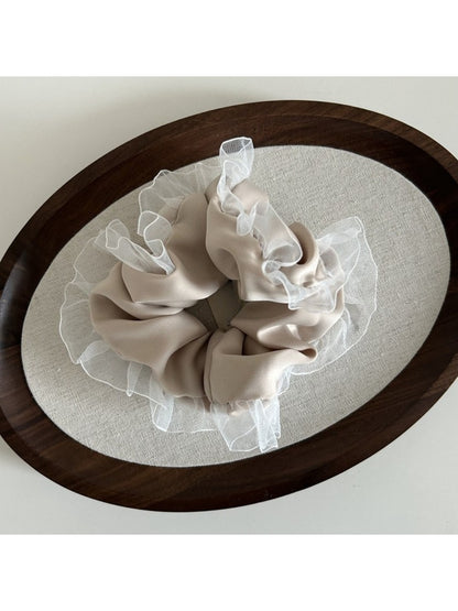 Gifty vintage tulle ruffle scrunchie wrapped around a ponytail