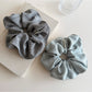 Vintage minimalist stripe scrunchie styled on a wrist with soft natural lighting