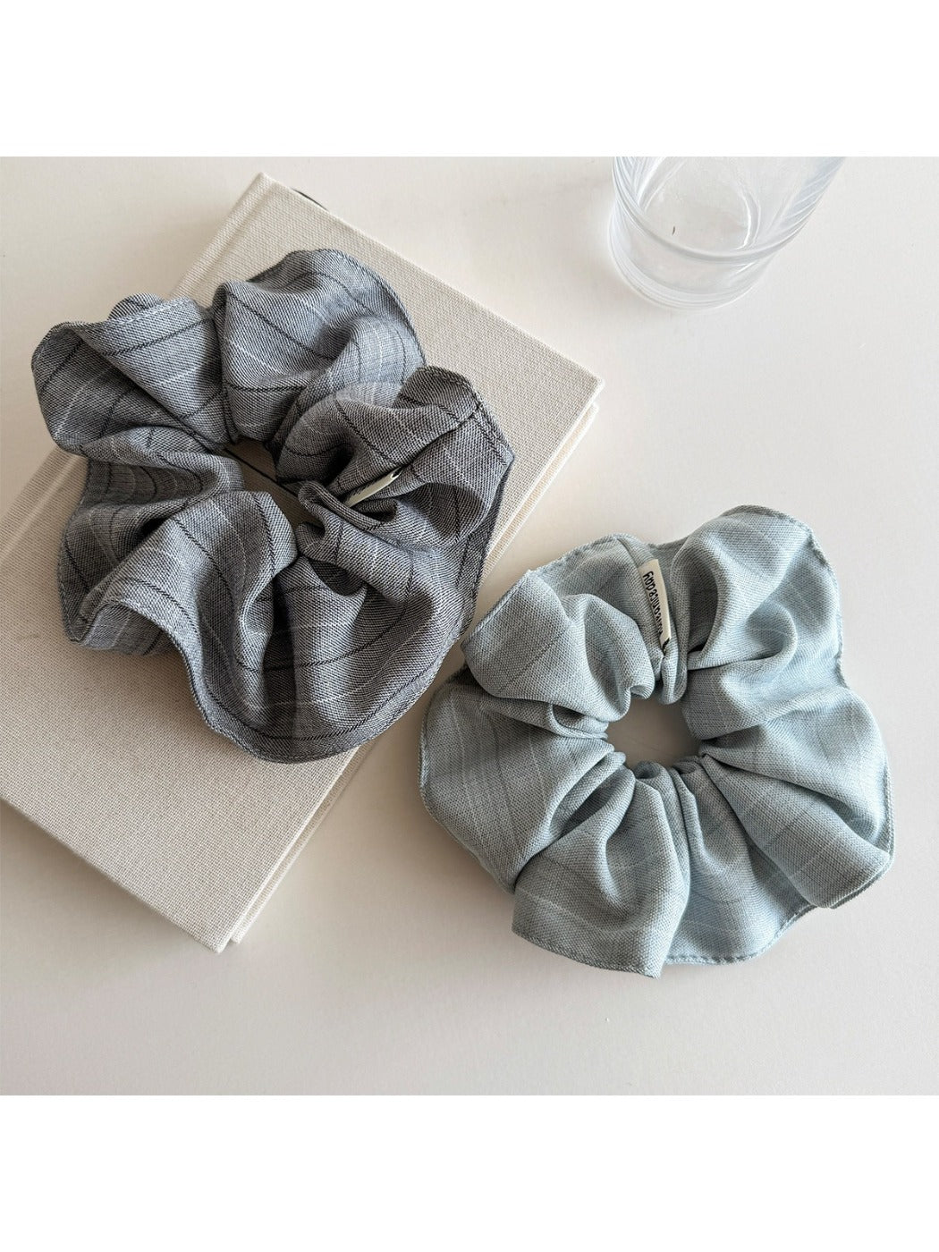 Vintage minimalist stripe scrunchie styled on a wrist with soft natural lighting