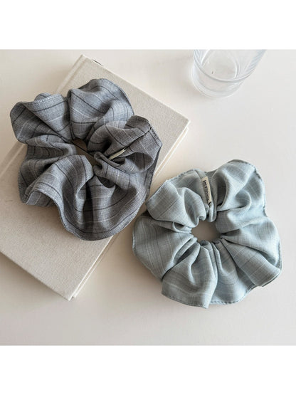 Vintage minimalist stripe scrunchie styled on a wrist with soft natural lighting