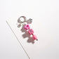 Beaded star keychain displayed with other small accessories on a table