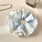 Gifty scrunchie styled in a ponytail with visible color block and polka dot details