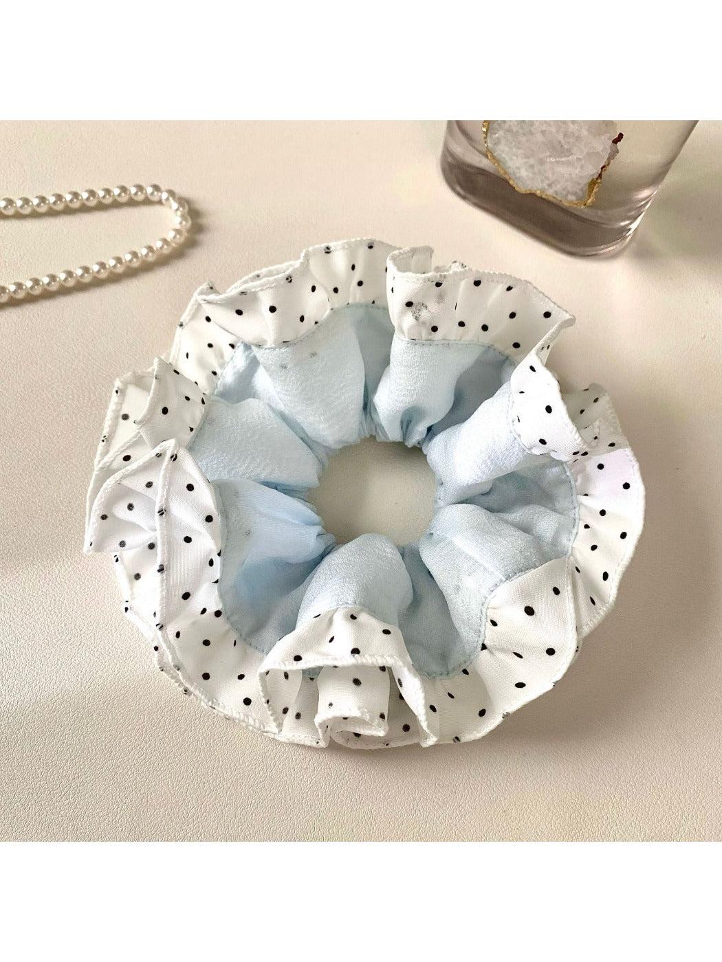 Gifty scrunchie styled in a ponytail with visible color block and polka dot details