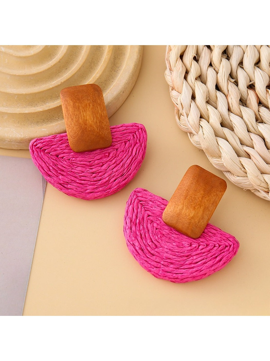Earedge raffia mushroom shaped stud earrings worn on a model's ear