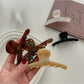 Side view of Beau elegant chic claw clip highlighting metal spring mechanism