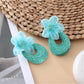 Sweet Raffia Flower Shaped Stud Earrings in a jewelry box with soft fabric lining