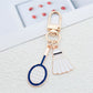 Close-up of badminton shuttlecock keychain showing detailed alloy craftsmanship