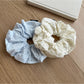 Gifty scrunchie styled on a wrist with visible print pattern