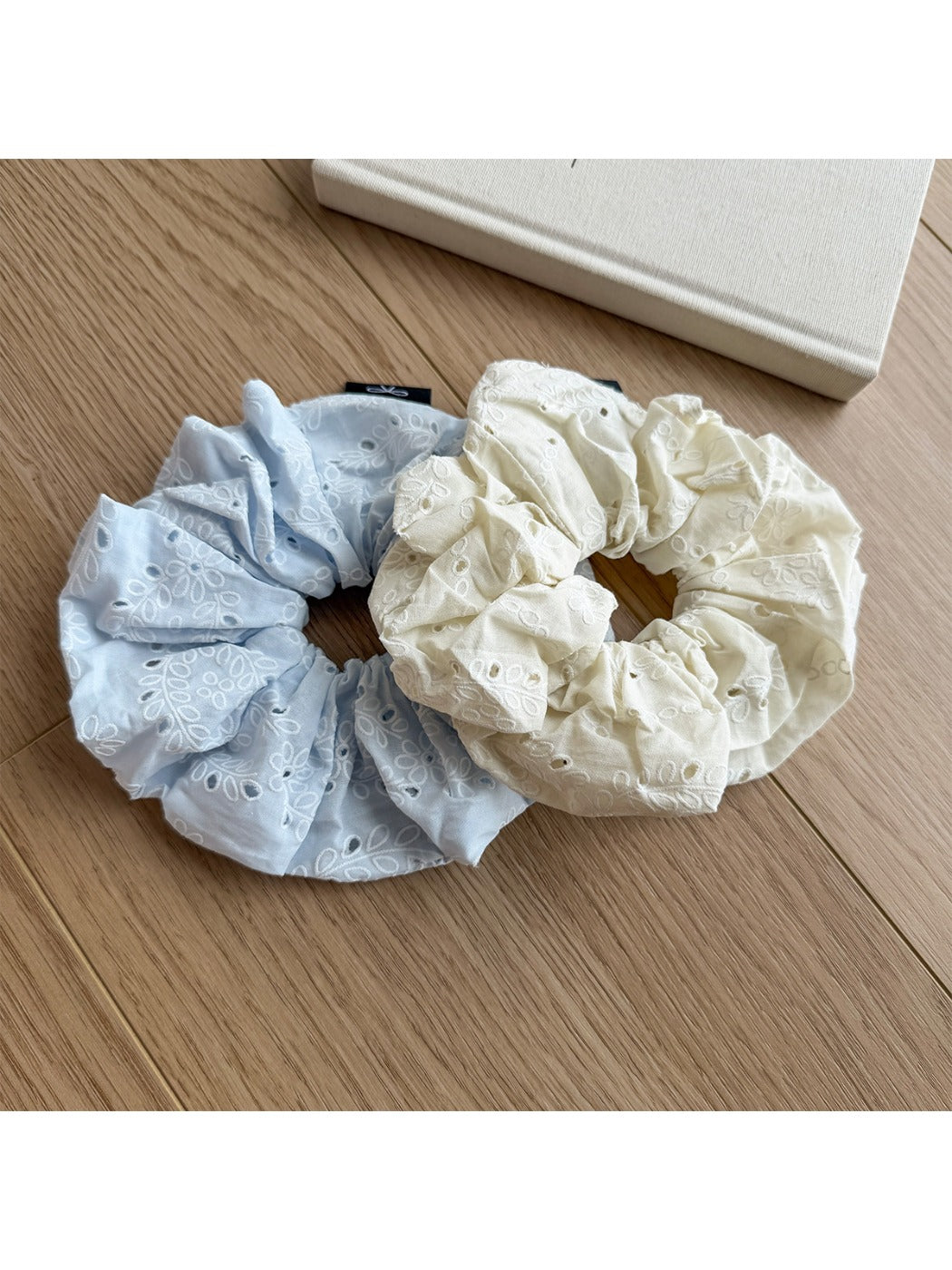 Gifty scrunchie styled on a wrist with visible print pattern