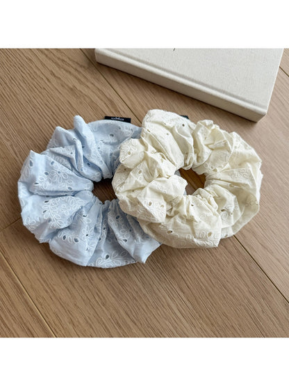 Gifty scrunchie styled on a wrist with visible print pattern