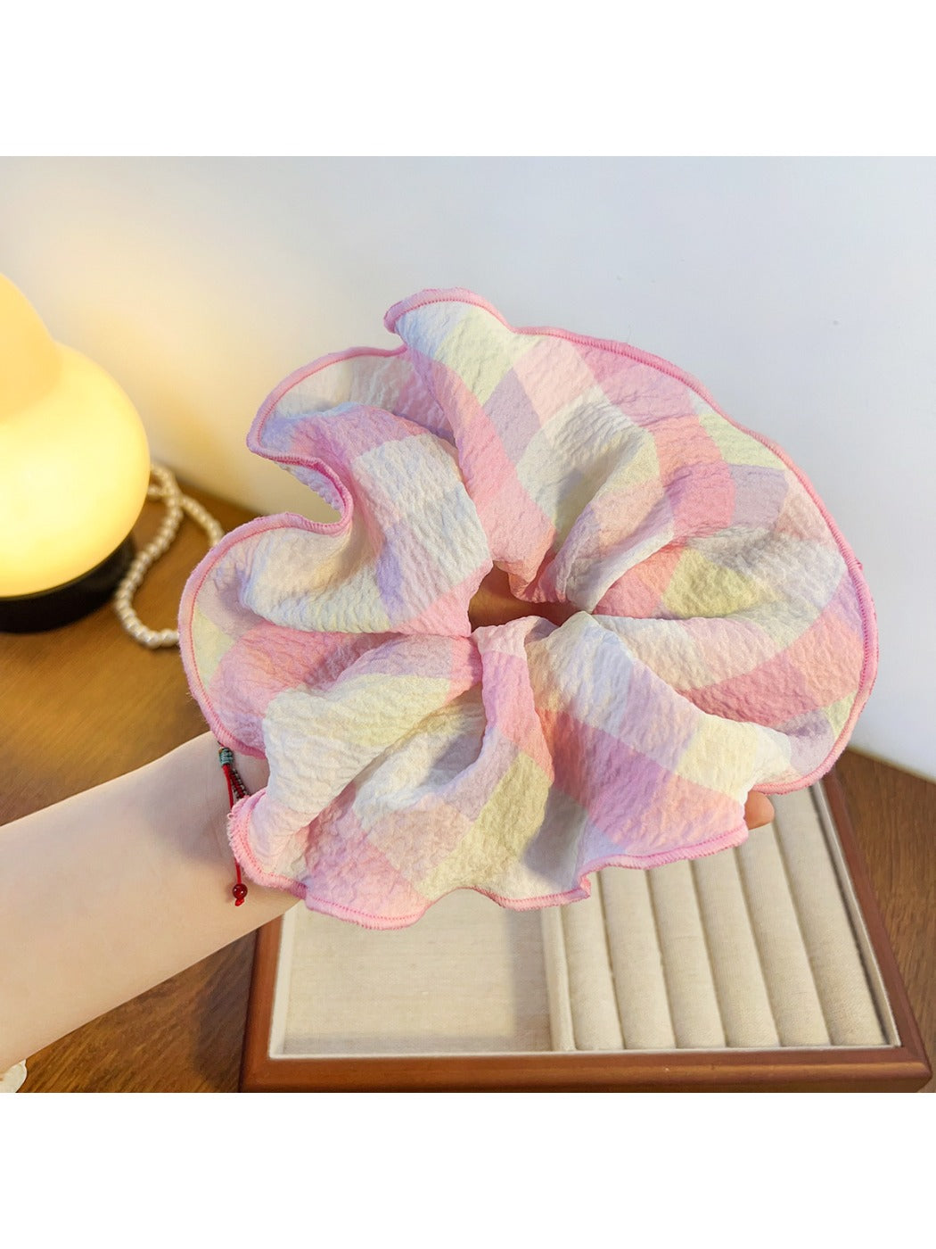 Gifty ruffled scrunchie in bright colors placed next to a small gift box