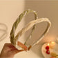 Close-up of Gifty sweet dainty beaded headband with small white beads on gold wire