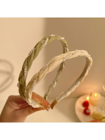 Close-up of Gifty sweet dainty beaded headband with small white beads on gold wire