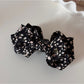 Beau small bow hair clip with pink floral pattern styled in hair