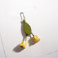 Hand holding the tulip flower shaped keychain with a blurred background