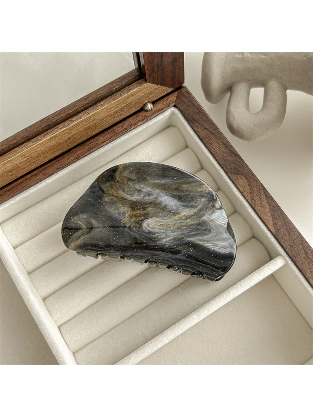 Beau gradient color blended claw clip placed on wooden surface
