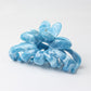 Beau hair clip positioned on a flat surface with natural lighting
