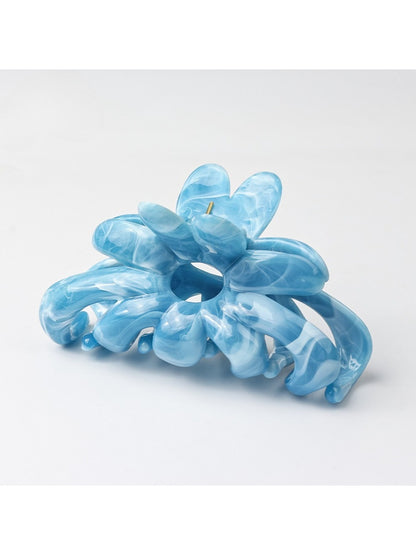 Beau hair clip positioned on a flat surface with natural lighting