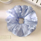 Side view of Gifty floral scrunchie showing ruched texture and fabric details
