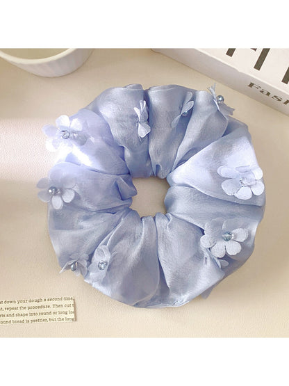 Side view of Gifty floral scrunchie showing ruched texture and fabric details