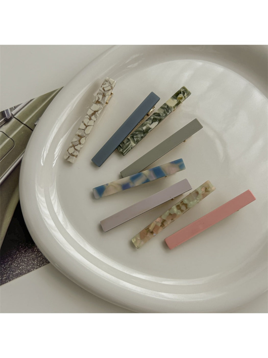 Close-up of Beau straight bar hair clip showing smooth acetate finish and clasp mechanism