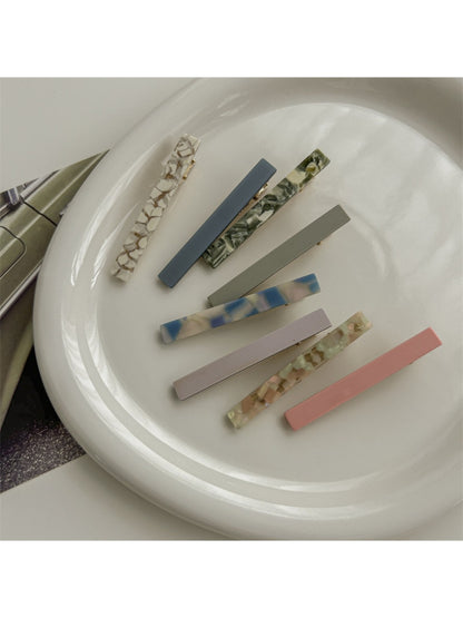 Close-up of Beau straight bar hair clip showing smooth acetate finish and clasp mechanism
