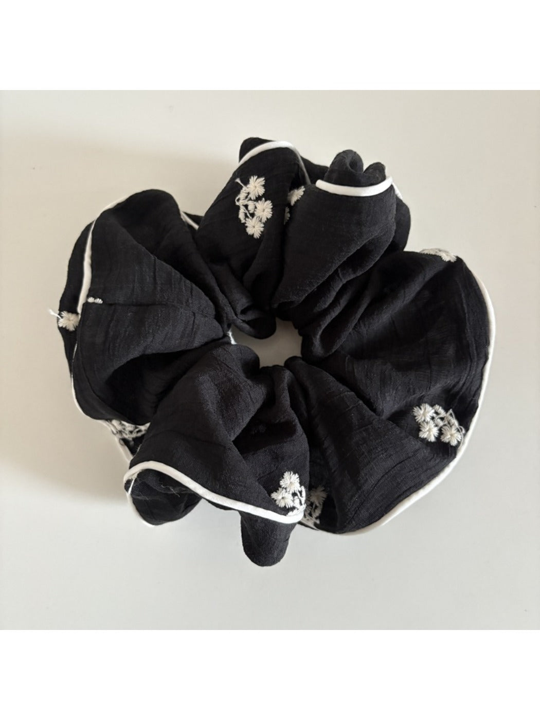Gifty small delicate mesh scrunchie styled in a woman's hair from the back
