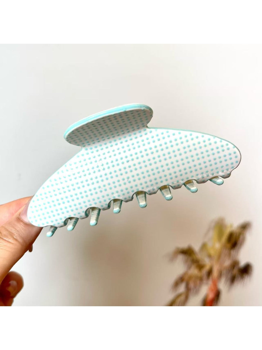 Beau polka dot acetate claw clip worn in long hair from back view