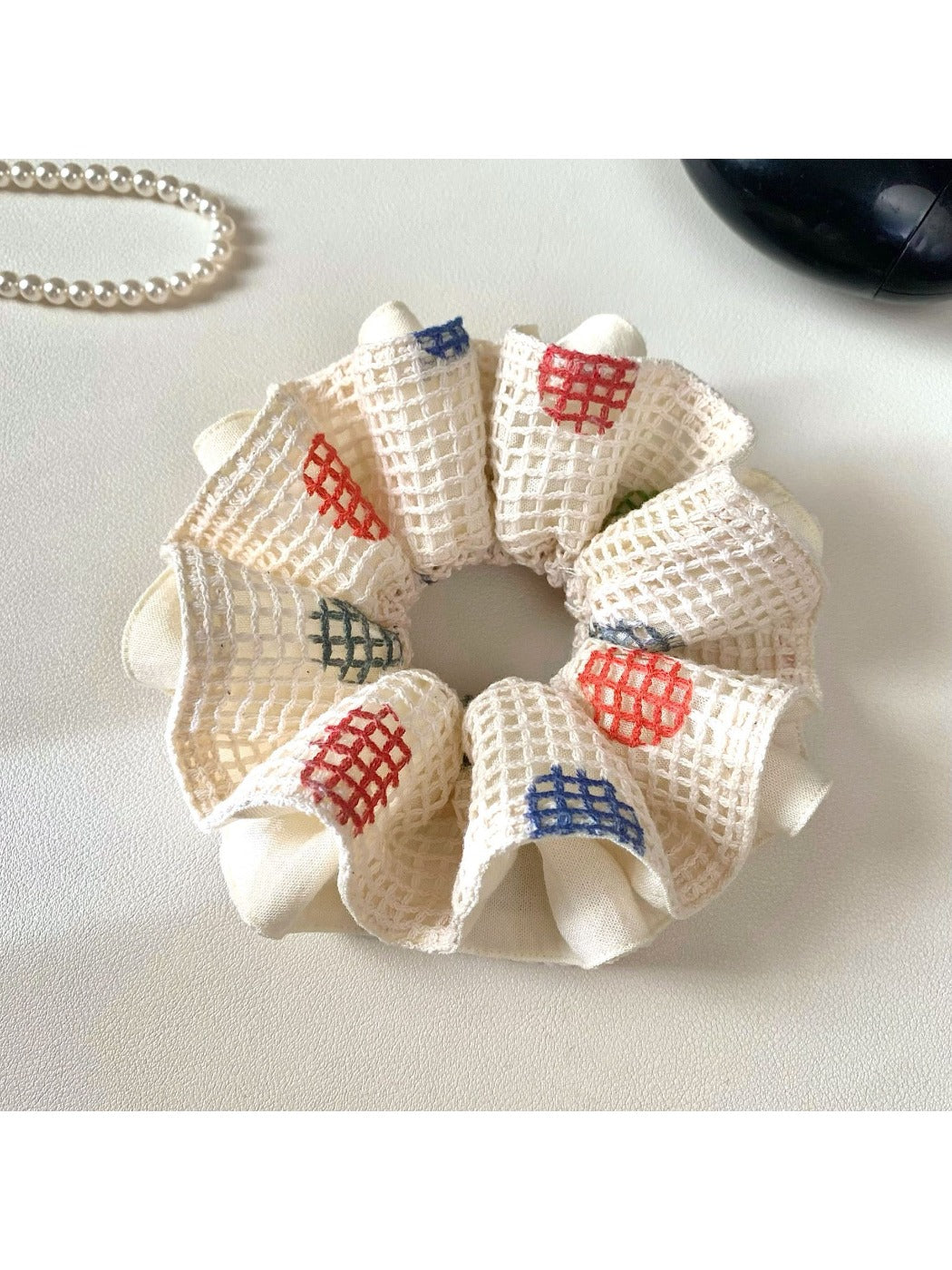 Gifty Lazy Style scrunchie with white polka dots on a light pink fabric