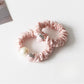 Close-up of a cute strawberry decorated hair tie with red and green colors