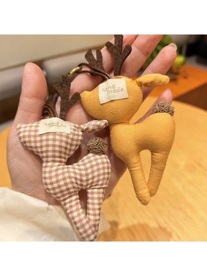 Keypus deer charm keychain hanging from a backpack zipper pull