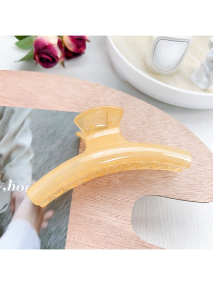 Pastel curved claw clip displayed alongside matching pastel hair accessories